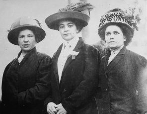 Early 20th century photo of three women in Lowell wearing elegant hats.